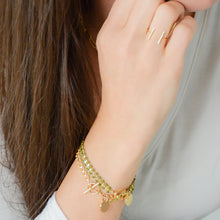 Load image into Gallery viewer, 14k gold-plated vine and leaf bracelet with olive green enamel and disc charm with cross
