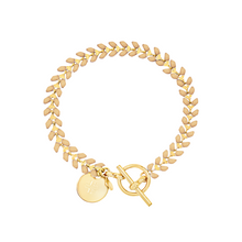 Load image into Gallery viewer, Vine gold-plated bracelet with nude color enamel, toggle, and disc charm with cross
