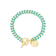 Load image into Gallery viewer, Vine gold-plated bracelet with turquoise enamel, toggle, and disc charm with cross