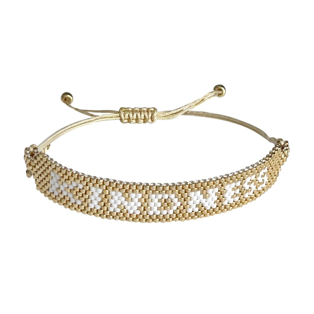 Kindness Gold and White beaded adjustable bracelet.