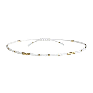 Gold and white beaded adjustable bracelet perfect for layering.