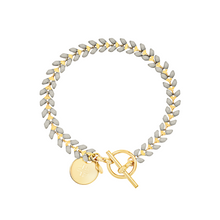 Load image into Gallery viewer, Vine gold-plated bracelet with slate gray enamel, toggle, and disc charm with cross
