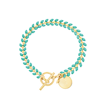 Load image into Gallery viewer, Vine gold-plated bracelet with turquoise enamel, toggle, and disc charm with cross

