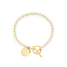 Load image into Gallery viewer, Vine gold-plated bracelet with white enamel, toggle, and disc charm with cross
